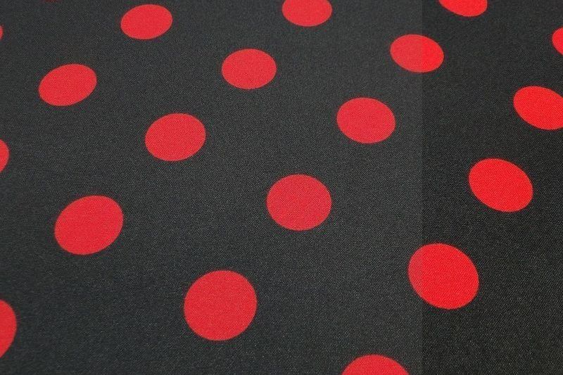 Texture stof zwart met rode stip