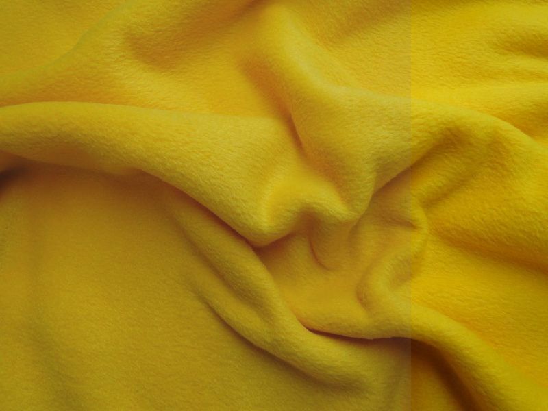 span Wijde selectie diefstal Fleece stof geel. FL035